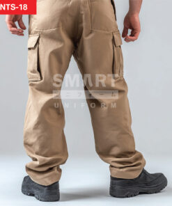 กางเกงยูนิฟอร์มทำงานขายาวสีกากี มุมด้านหลังเห็นทรงกระบอกและแนวตะเข็บช่วงสะโพก มีกระเป๋าคาร์โก้ด้านข้างฝาปิดทั้งสองข้าง ชายขาเรียบไม่มีแถบสะท้อนแสง ใส่รองเท้านิรภัยสีดำ ฉากสตูดิโอพื้นเทาอ่อน